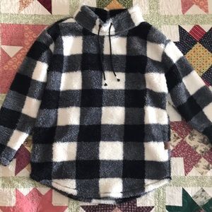 Medium ladies warm fuzzy sweater worn once. Pockets but no hood. Black & white